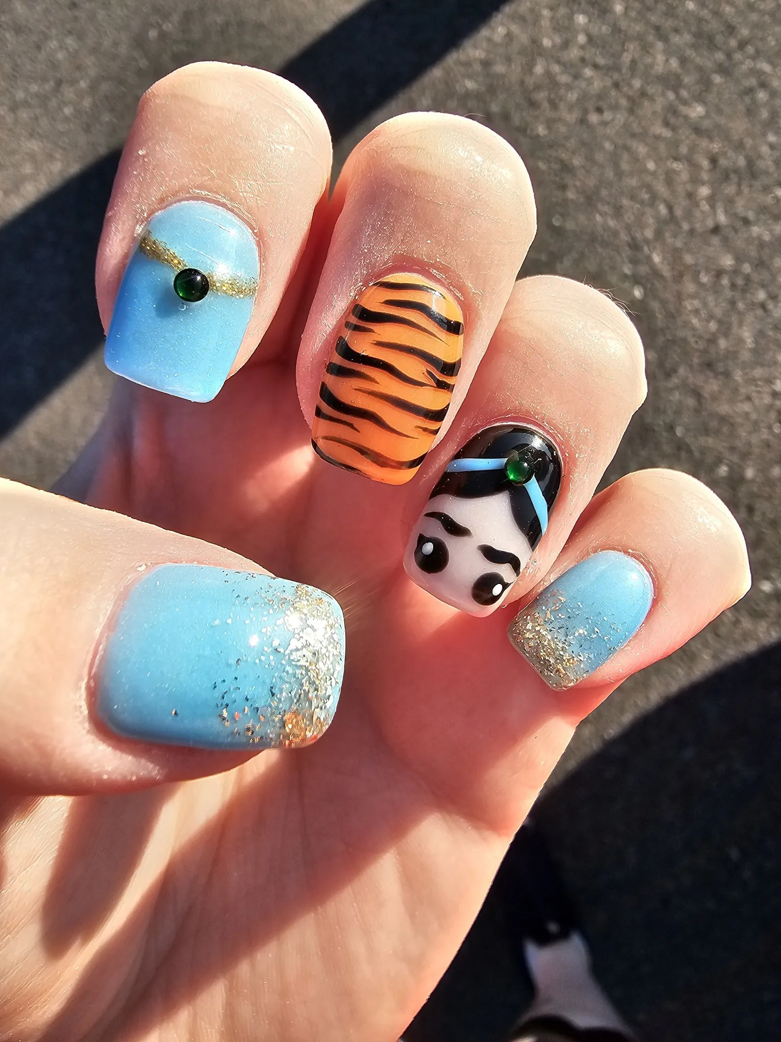These gorgeous nails channel Jasmine’s signature look — shimmering blue, golden accents, and a touch of tiger print. It’s a royal mani with a little edge, perfect for your next Disneybound outfit.