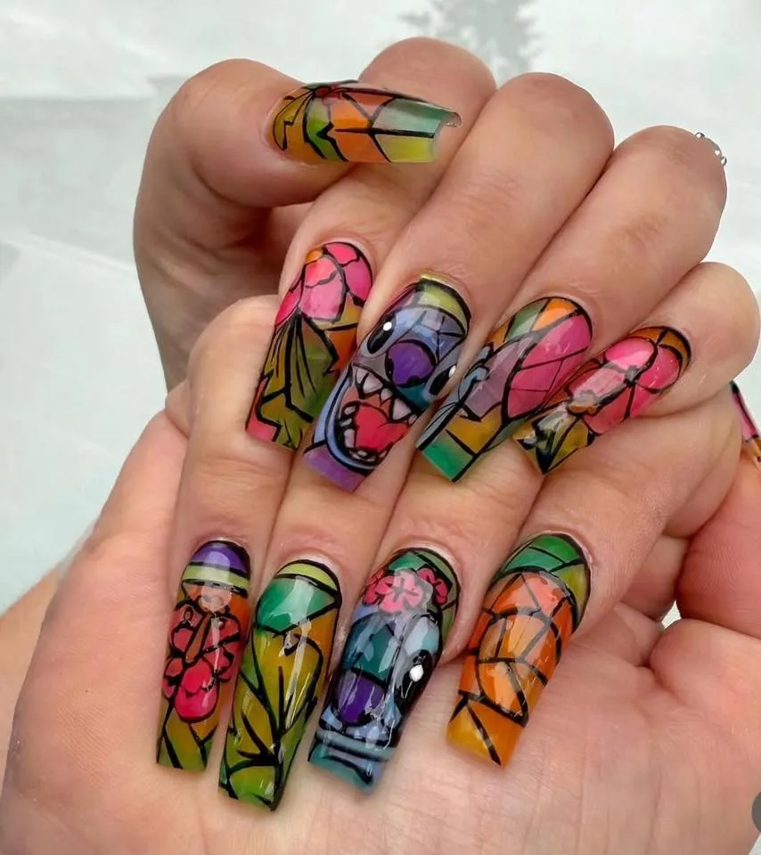 These stained-glass-style Stitch nails are pure artistry. The vivid mosaic colors and outlined details create a dramatic, almost window-like effect — a masterpiece for anyone who loves bold, creative designs.