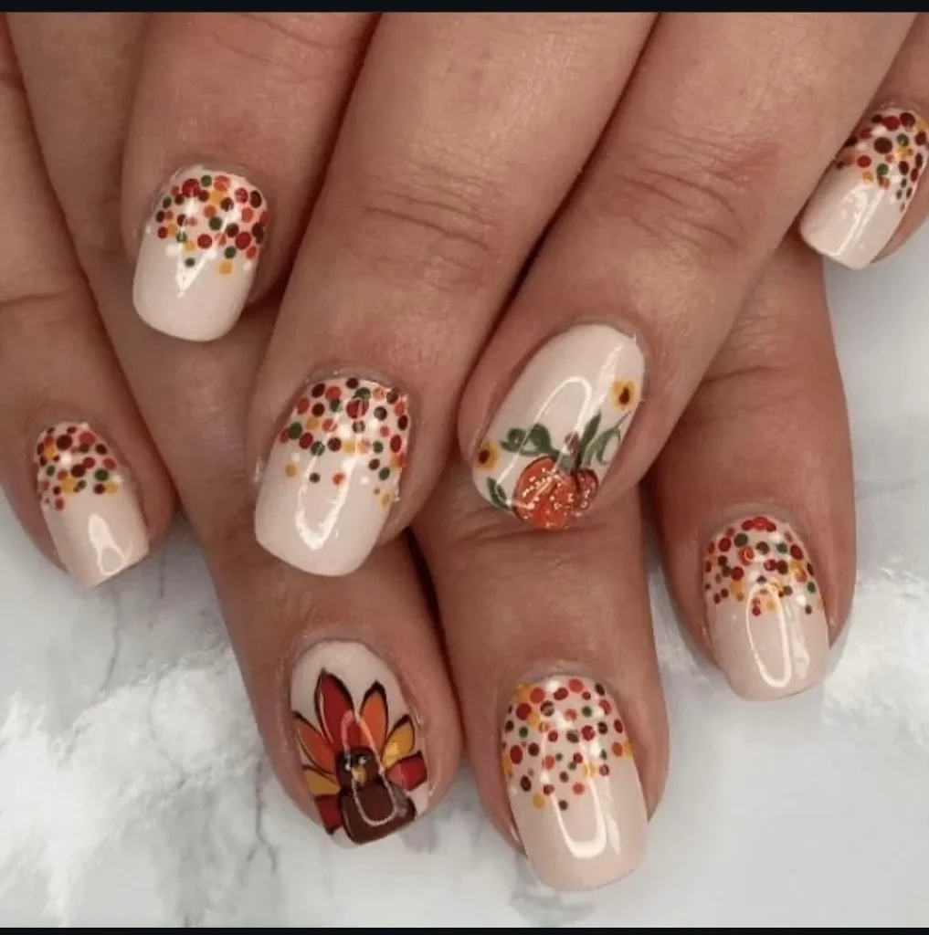 Soft neutrals and tiny dots create the prettiest base for cute turkey and pumpkin accents. This look proves Thanksgiving nails can be festive without being over the top — perfect for anyone who loves simple fall nails.
