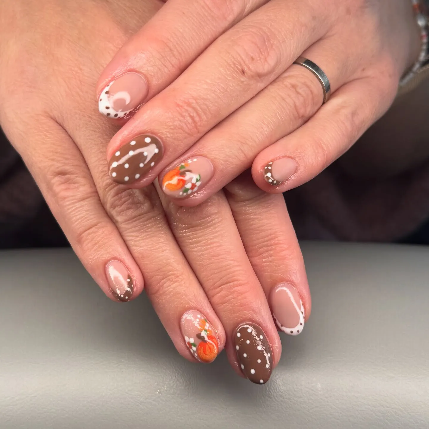 Brown and beige polka dots with a tiny pumpkin accent make this look irresistibly cute. A sweet take on minimalist autumn nails that still show off your creative side.