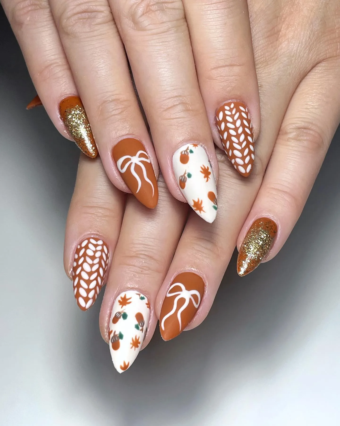 Pumpkins, acorns, and cozy orange tones come together for this adorable harvest set. These brown fall nails are giving pumpkin patch perfection.