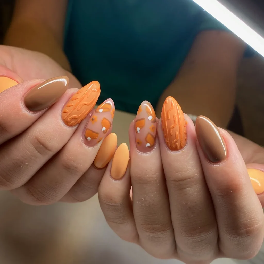 Sweater-inspired texture and pumpkin-spice shades take center stage in this cozy fall manicure. The orange and tan combo gives major November nails vibes while keeping things soft and seasonal.