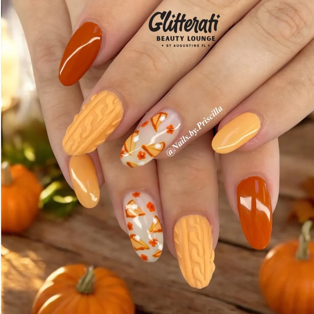 Warm pumpkin tones and soft cable-knit accents make these nails feel like a pumpkin-spice latte in manicure form. Add in a few floral details and you’ve got simple fall nails that are perfect for Thanksgiving dinner.