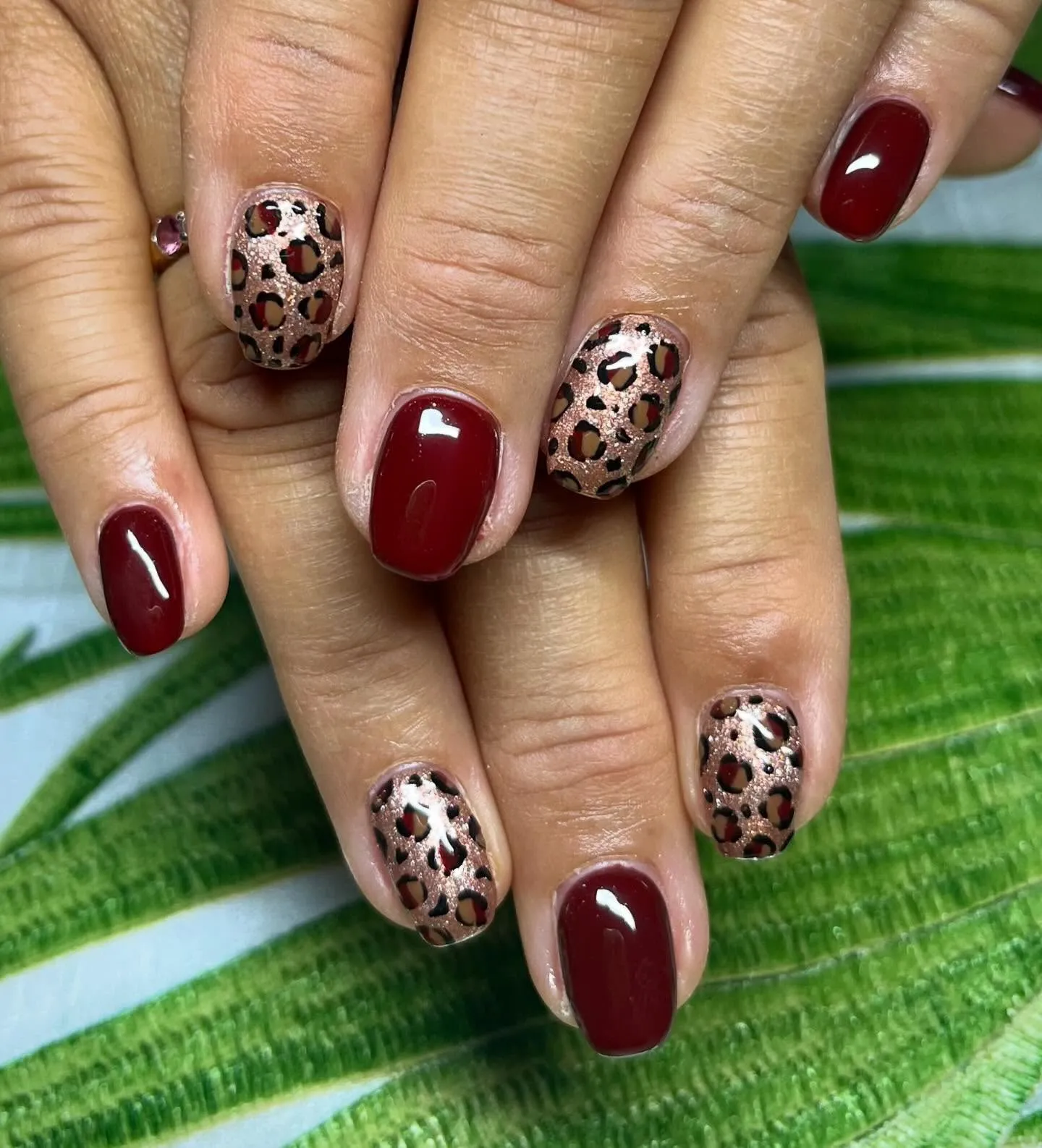 @nails_and_beauty_by_daisy keeps it chic with a nude base and dainty pink-toned leopard spots. The subtle swoop of black on the French tips adds just the right amount of edge.