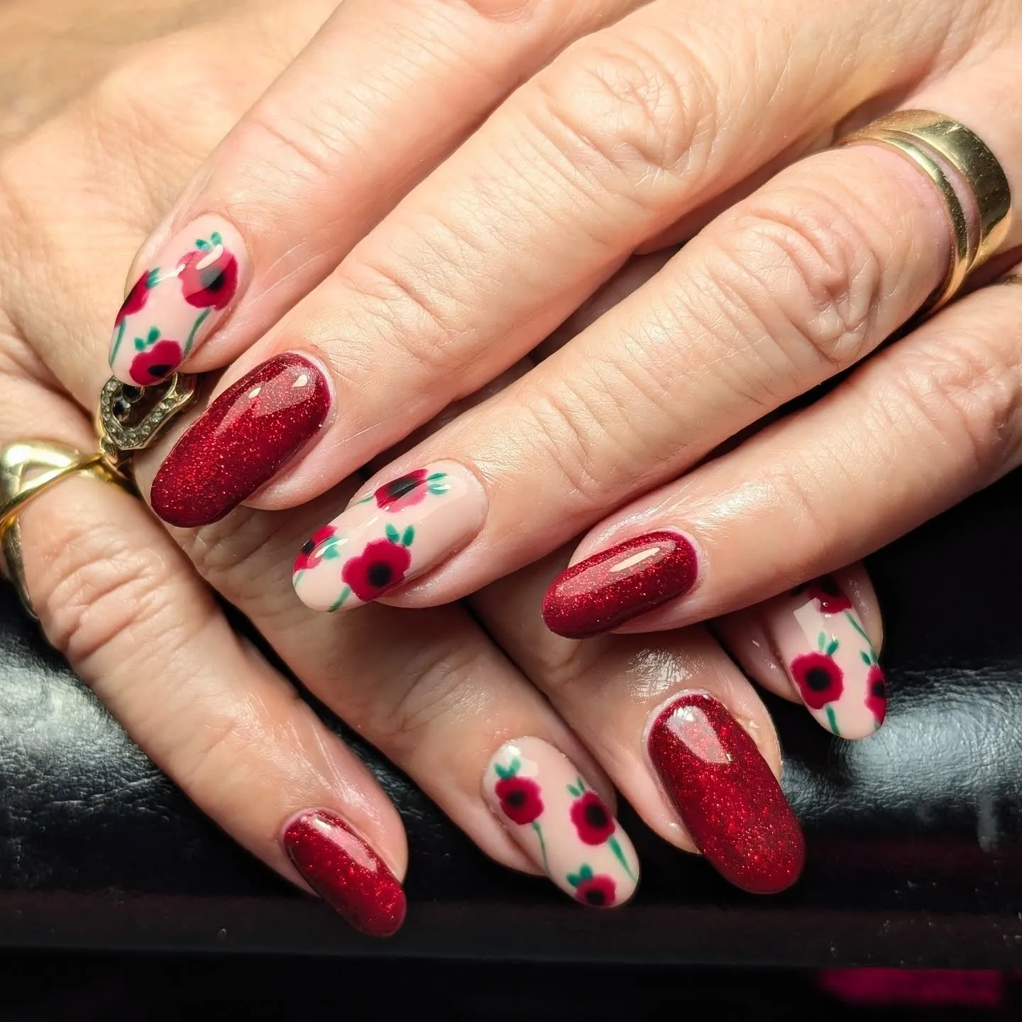 Classic and elegant, this poppy nail design by @polish_me_pretty_nailstudio pairs nude and red tones for a soft, feminine look. The scattered red petals against neutral nails make this a lovely choice for anyone wanting something meaningful but still elegant.